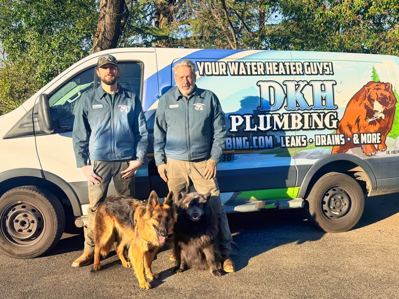 Brian and Damon Hoddick with their dogs by the DKH Plumbing van in Nevada City