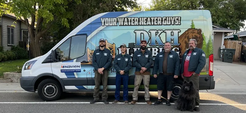 The full DKH Plumbing crew with their dog