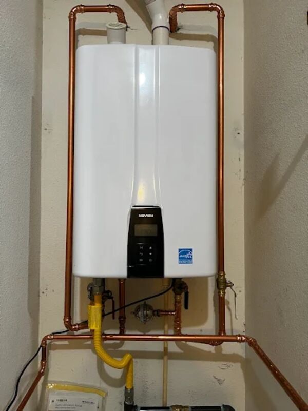DKH Plumbing technician repairing a tankless water heater