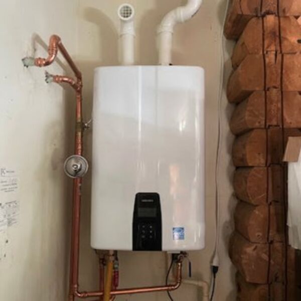 DKH Plumbing technician installing a tankless water heater