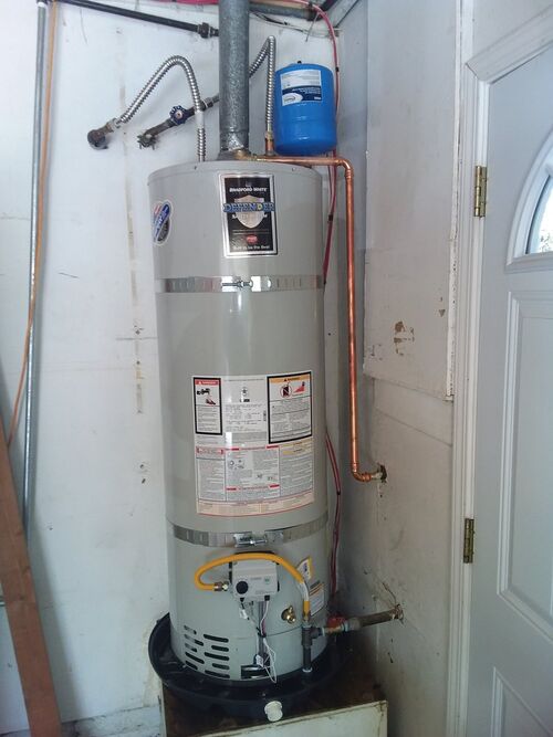 DKH Plumbing technician working on a water heater installation